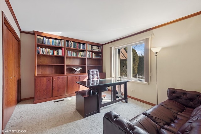 home office featuring light carpet, crown molding, visible vents, and baseboards