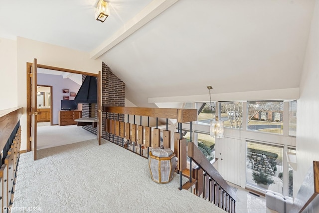 hall featuring vaulted ceiling with beams, carpet, and an upstairs landing