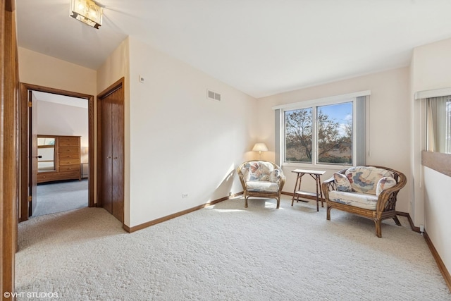 living area with carpet floors, visible vents, and baseboards