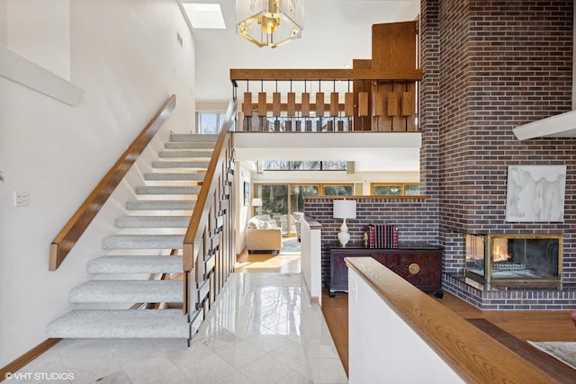 staircase featuring tile patterned flooring, a fireplace, and a high ceiling