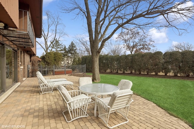 view of patio featuring outdoor dining area and fence