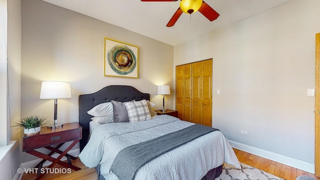 bedroom with ceiling fan, a closet, wood finished floors, and baseboards