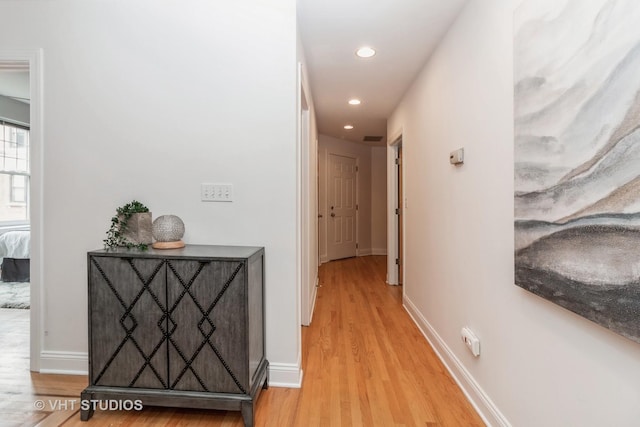 hall with light wood finished floors, recessed lighting, and baseboards