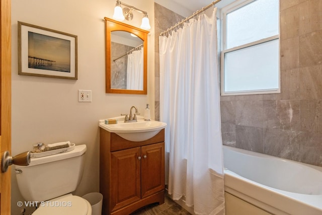 bathroom featuring shower / tub combo, vanity, and toilet