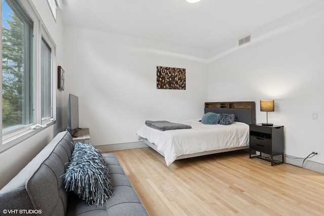 bedroom featuring visible vents and light wood-style flooring