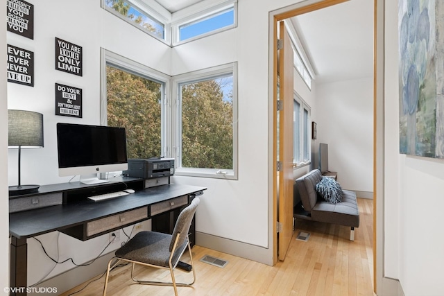 home office with visible vents, baseboards, and wood finished floors