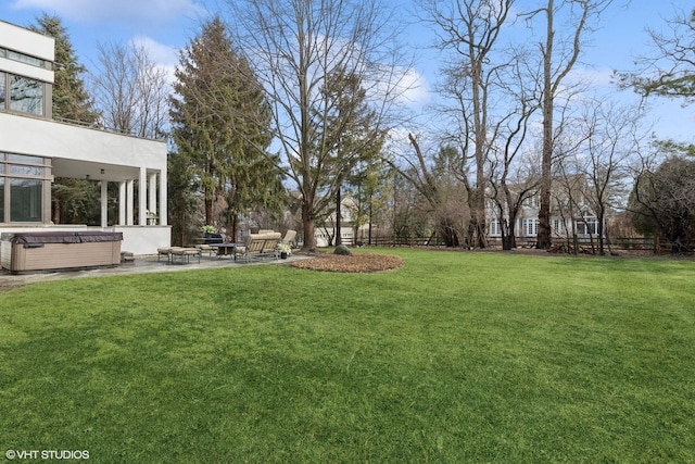 view of yard featuring a patio, a hot tub, and fence