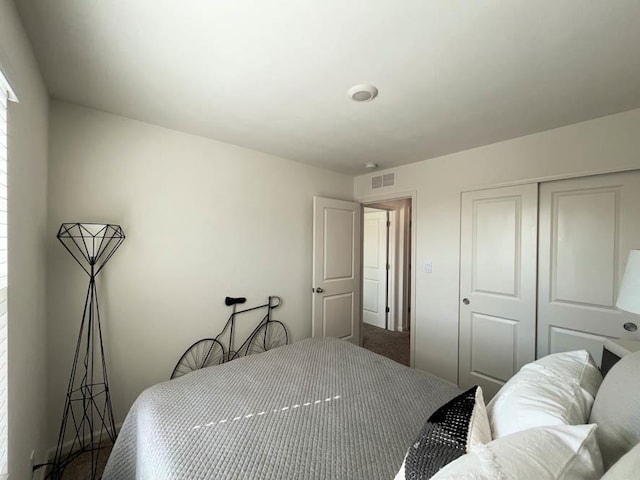 bedroom with a closet and visible vents