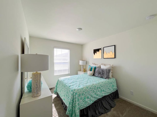 carpeted bedroom featuring baseboards