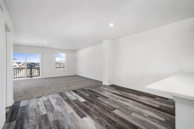 interior space with dark wood-type flooring, recessed lighting, and baseboards