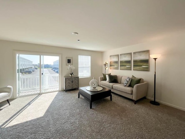 carpeted living room featuring baseboards