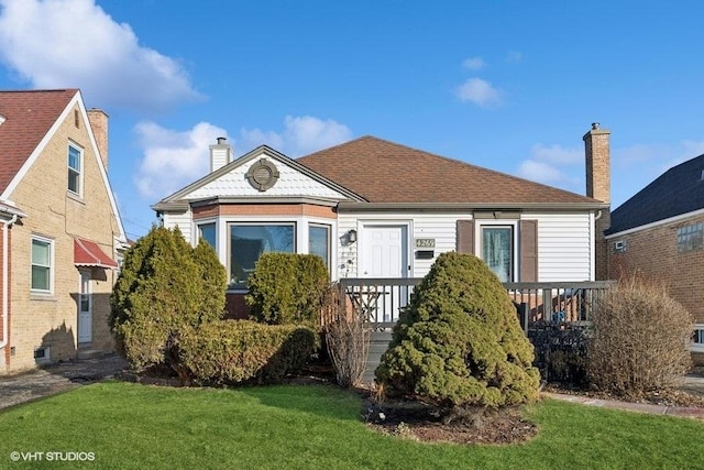 bungalow with a chimney and a front yard