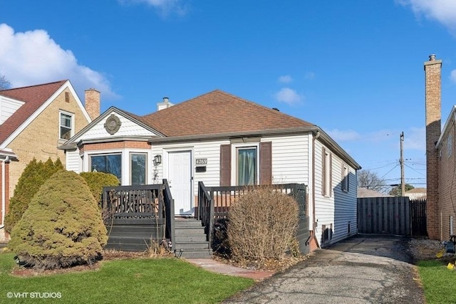 bungalow featuring roof with shingles