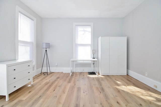 interior space featuring wood finished floors and baseboards