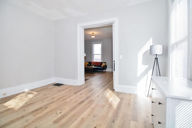 interior space with light wood-style flooring and baseboards