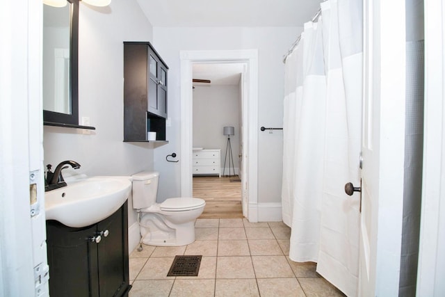 bathroom featuring visible vents, toilet, vanity, tile patterned flooring, and baseboards