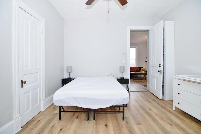 bedroom with light wood-style floors and ceiling fan