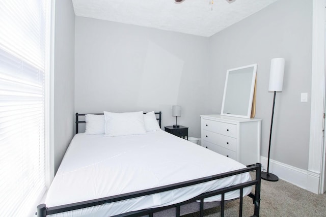 bedroom with carpet floors, a ceiling fan, and baseboards