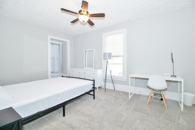 bedroom featuring carpet flooring, ceiling fan, a textured ceiling, and baseboards