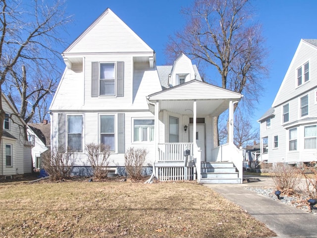 view of front of property with a porch and a front yard