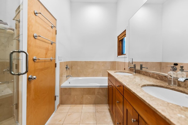 bathroom with tile patterned flooring, a sink, a bath, and a shower stall