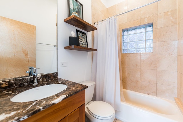 bathroom with toilet, shower / bath combo, and vanity