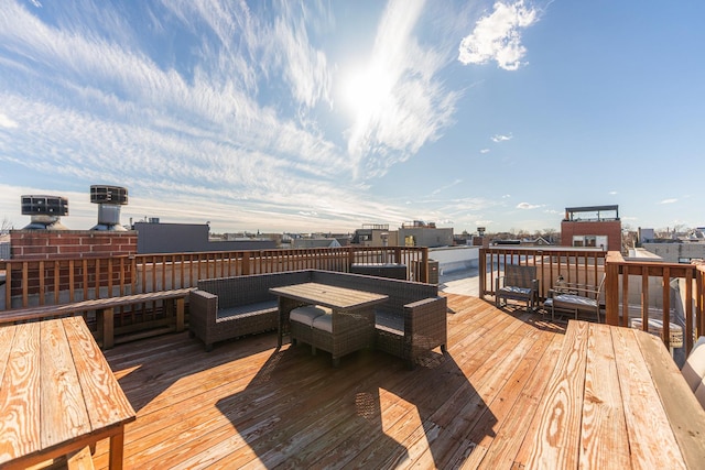 deck with an outdoor living space and a city view