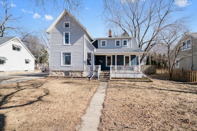 view of front of house with a shingled roof, covered porch, a chimney, and fence