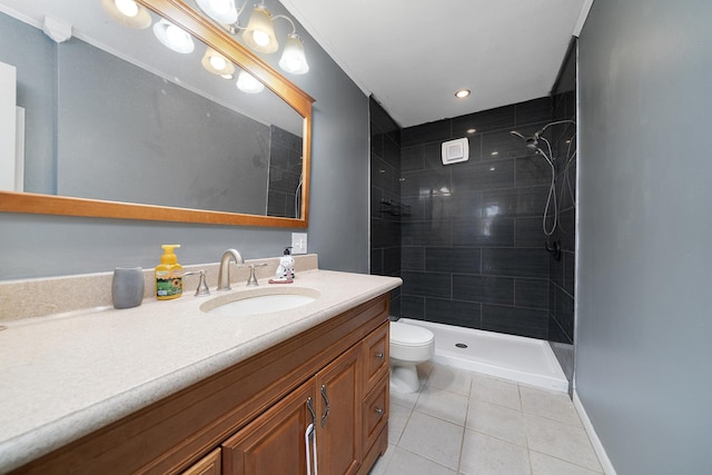 bathroom featuring tile patterned floors, tiled shower, toilet, and vanity