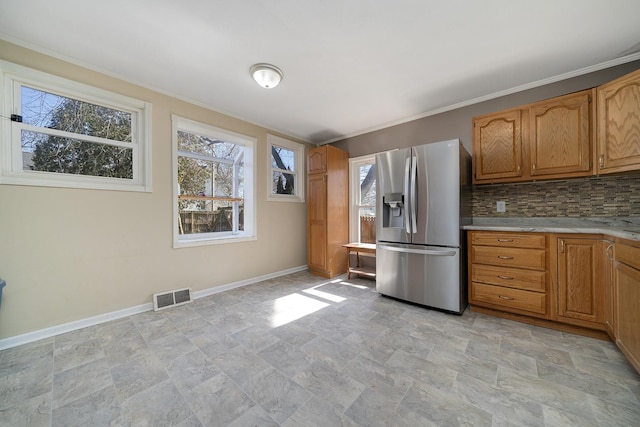 kitchen with visible vents, a healthy amount of sunlight, light countertops, and stainless steel fridge with ice dispenser