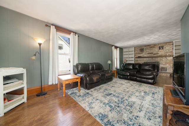 living area with wood finished floors and a fireplace