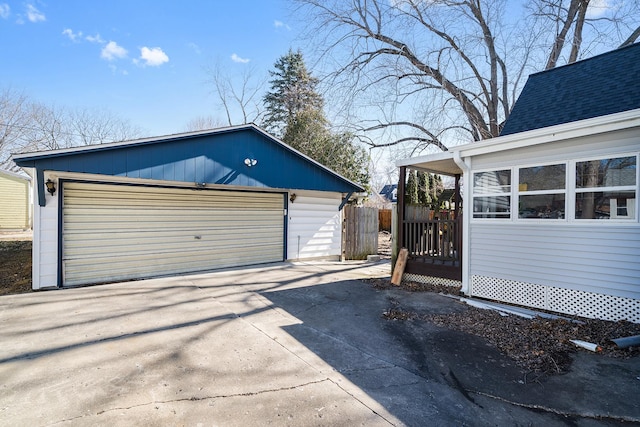 detached garage featuring fence