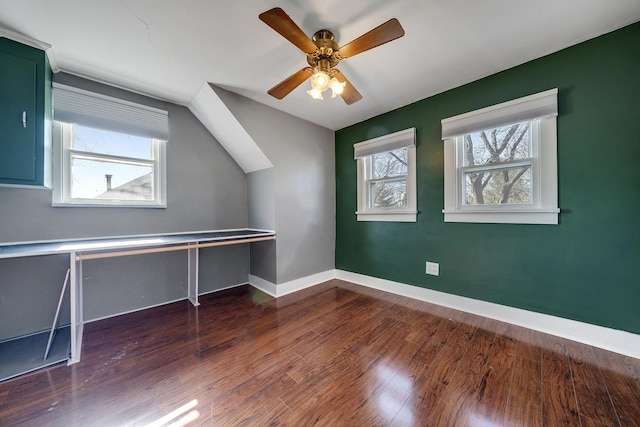 bonus room featuring a healthy amount of sunlight, a ceiling fan, baseboards, and wood finished floors