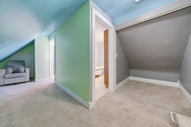 bonus room with vaulted ceiling, carpet, and baseboards