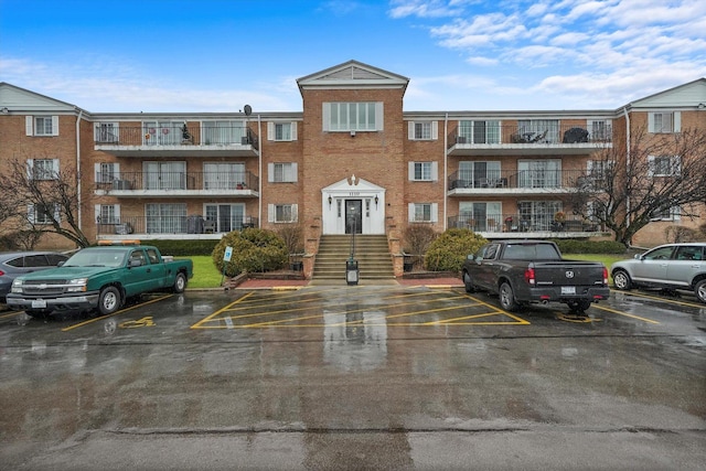 view of building exterior with uncovered parking