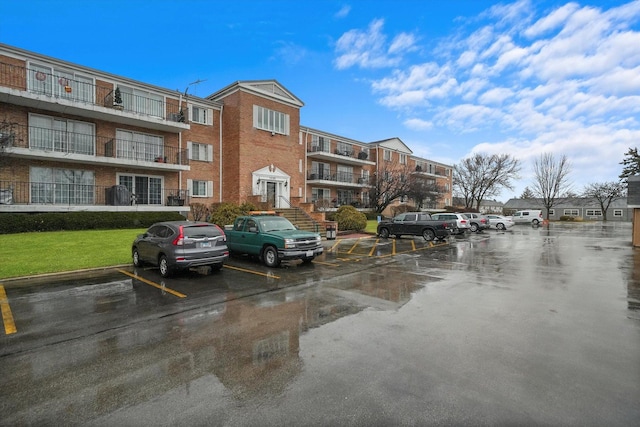 view of building exterior featuring uncovered parking