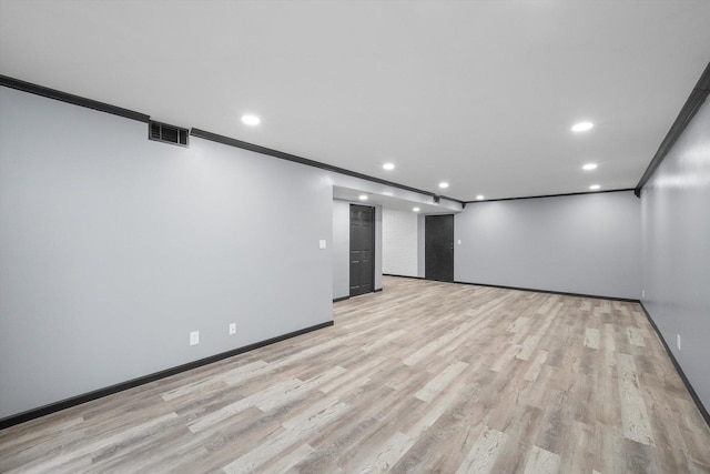 empty room featuring recessed lighting, visible vents, crown molding, and light wood-style flooring