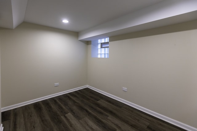 basement with dark wood-style floors, baseboards, and recessed lighting