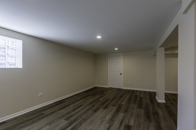 below grade area featuring baseboards, dark wood-style flooring, and recessed lighting