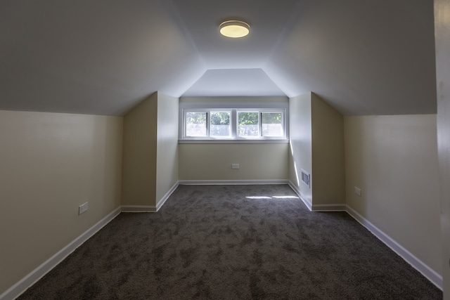 bonus room featuring carpet flooring, visible vents, vaulted ceiling, and baseboards