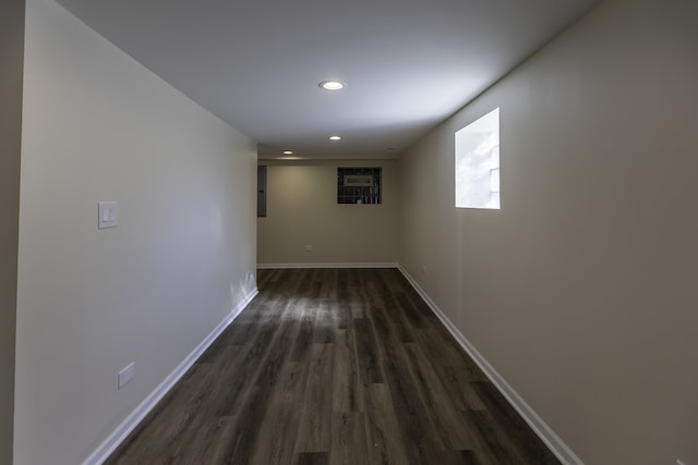 hallway with baseboards, dark wood-type flooring, and recessed lighting