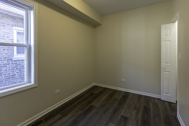 unfurnished room with dark wood-style floors and baseboards