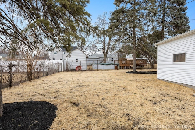 view of yard with fence and a deck