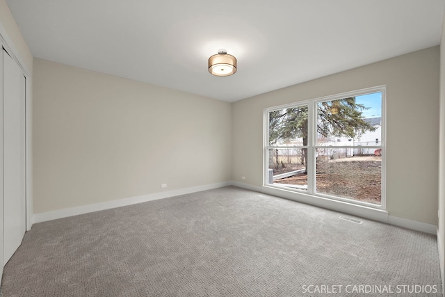 interior space featuring a closet, carpet flooring, and baseboards