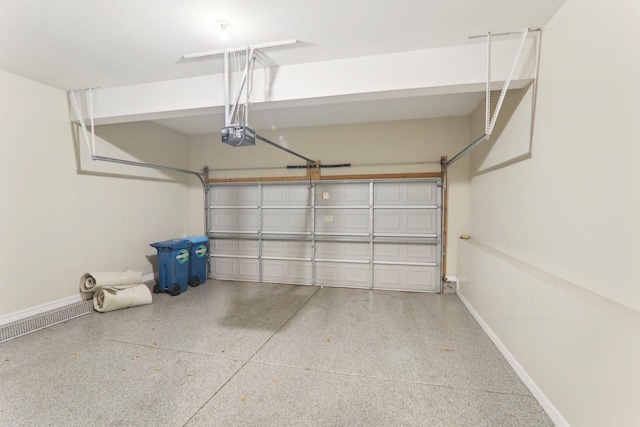 garage with a garage door opener and baseboards