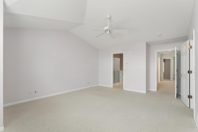 unfurnished bedroom featuring lofted ceiling, ceiling fan, light colored carpet, and baseboards