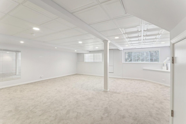 below grade area featuring plenty of natural light, carpet flooring, and baseboards