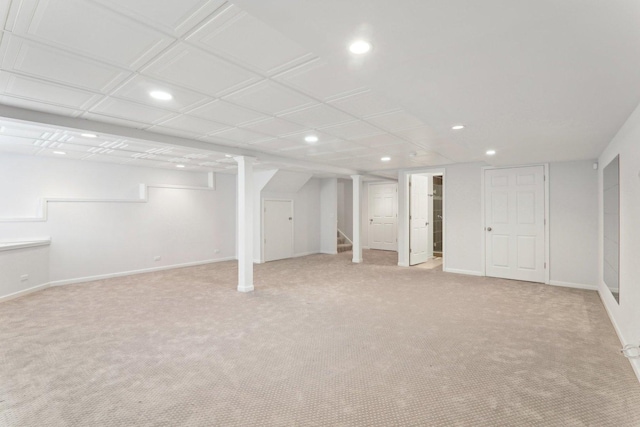 finished basement featuring stairway, recessed lighting, light colored carpet, and baseboards