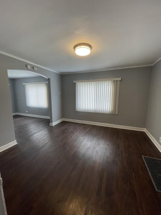 spare room featuring visible vents, crown molding, and baseboards