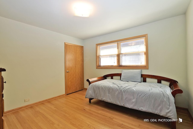 bedroom featuring light wood-style floors and baseboards